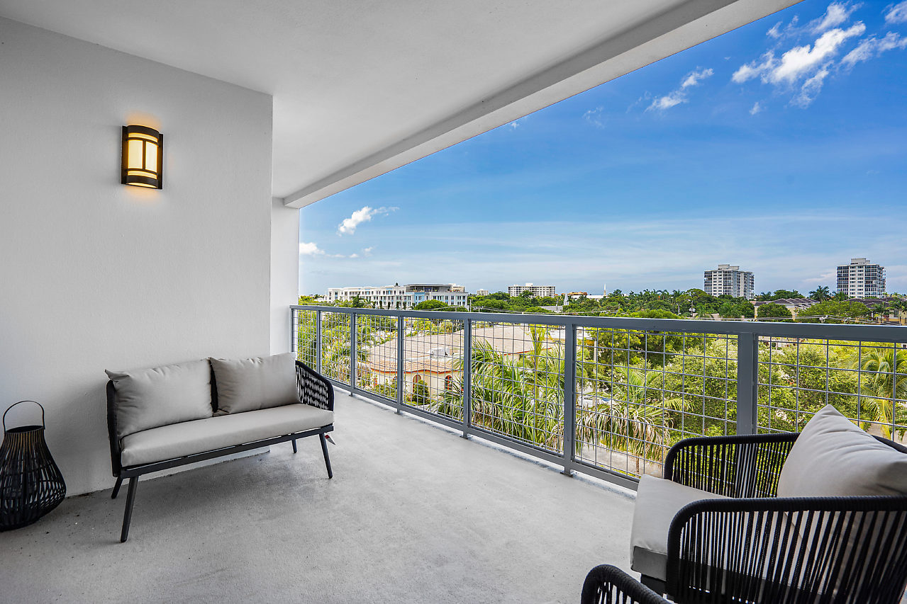 B2 floorplan balcony with lounge chairs overlooking downtown Delray Beach